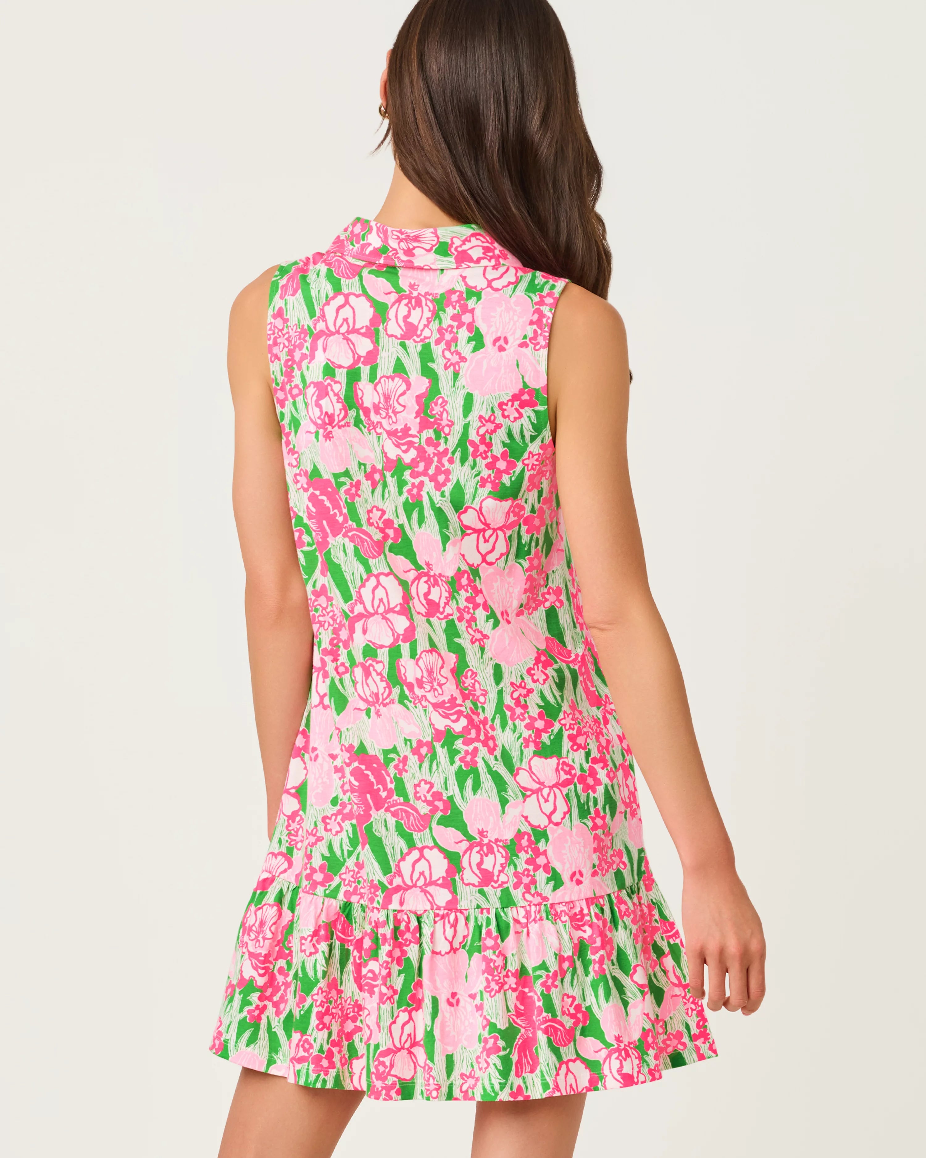 Woman wearing a pink floral dress on a white background
