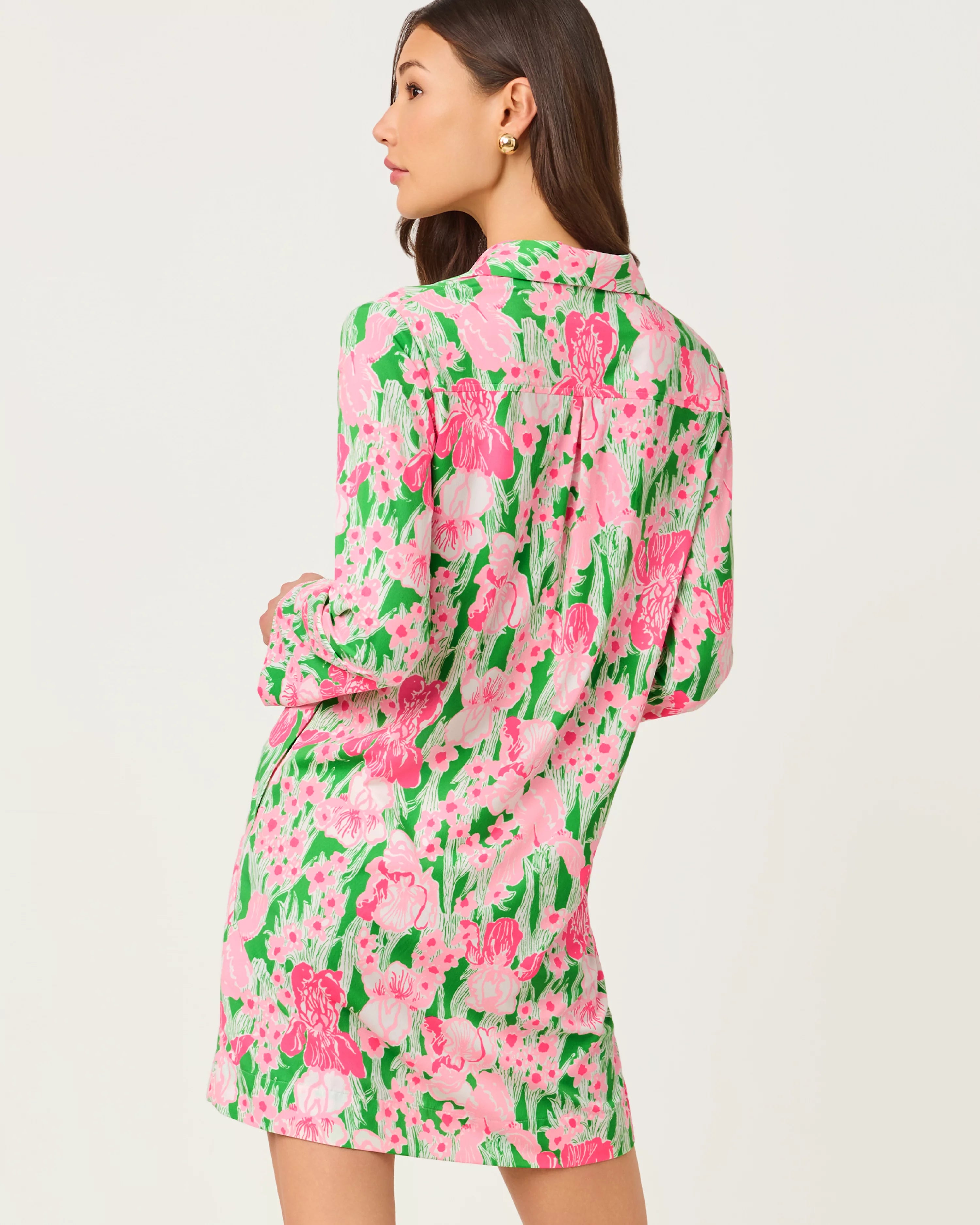 Woman wearing a pink floral dress on a white background