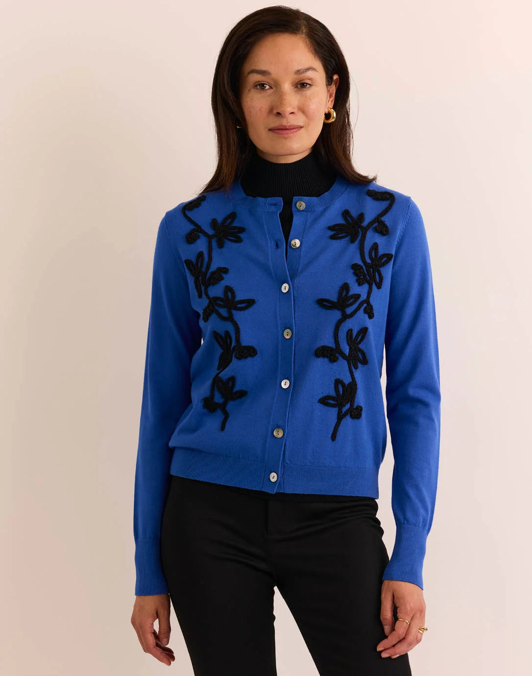Woman wearing a blue cardigan with black floral embroidery by The H Edition Kaylee Long Sleeve Embroidery Cardigan Electric Blue