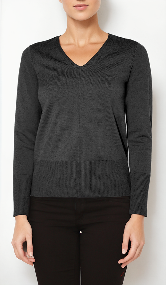 Person wearing a black sweater against a white background