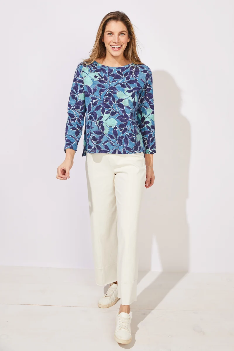 Woman wearing a blue floral patterned top ESCAPE BY HABITAT FOLIAGE FLORAL COTTON BOXY TEE - 12125 Color Harbor