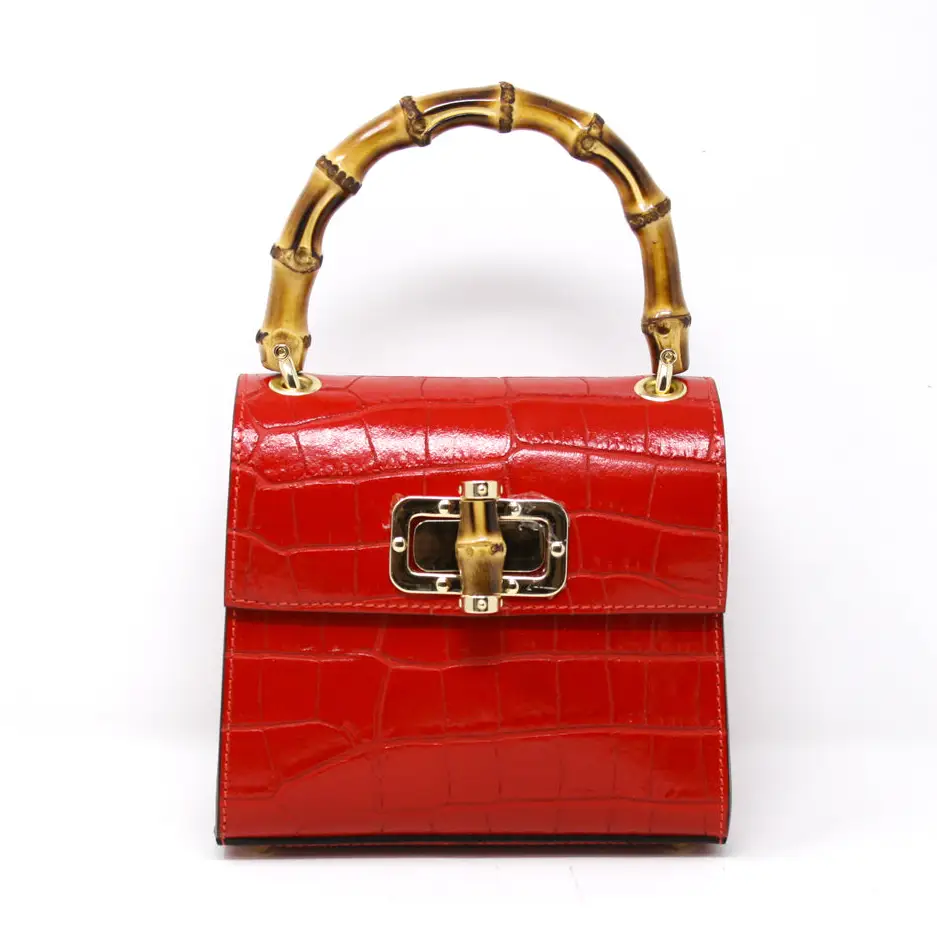 Women’s red handbag with gold details and bamboo handle