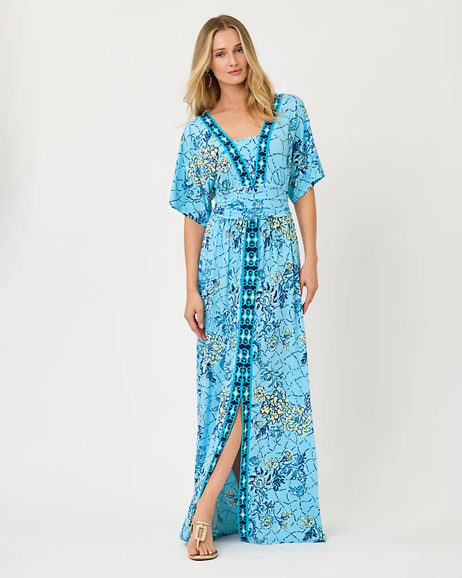 Woman wearing a blue floral dress on a white background