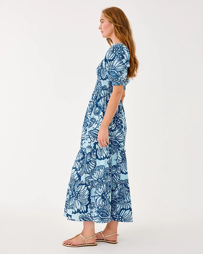 Woman wearing a blue floral dress on a white background