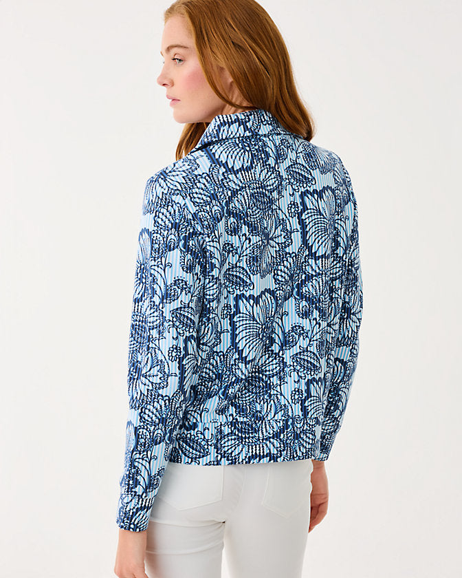 Woman wearing a blue floral patterned shirt on a white background