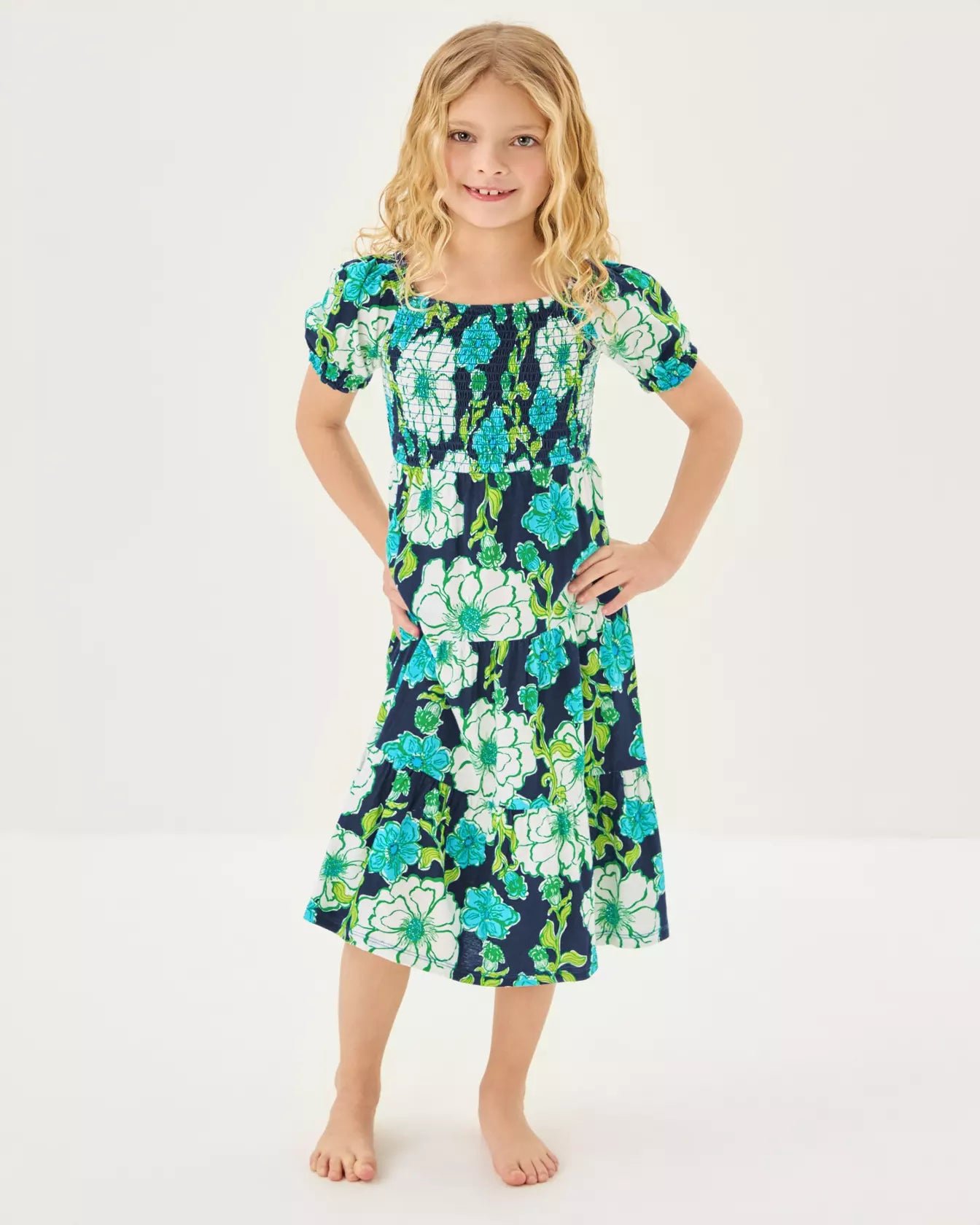 Young girl wearing a floral dress on a white background