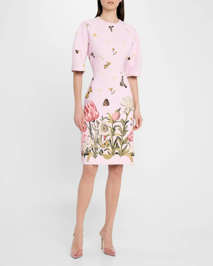 Woman wearing a pink dress with floral and butterfly pattern