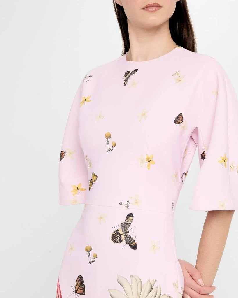Pink blouse with butterfly and floral patterns worn