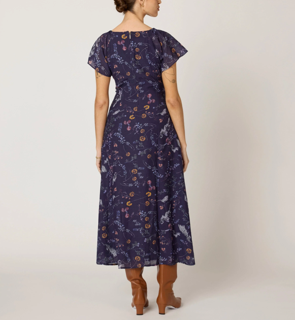 woman wearing dark blue floral dress back view