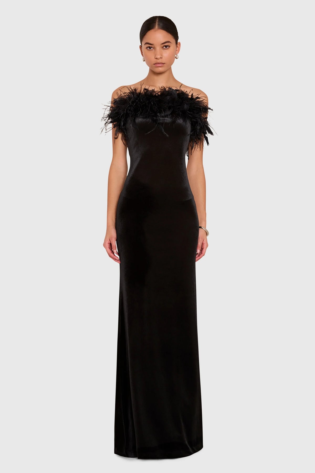 The Amanda Uprichard Ella Gown in black, a rich plush velvet. Strapless and finished with an ostrich feather trim at the neckline.