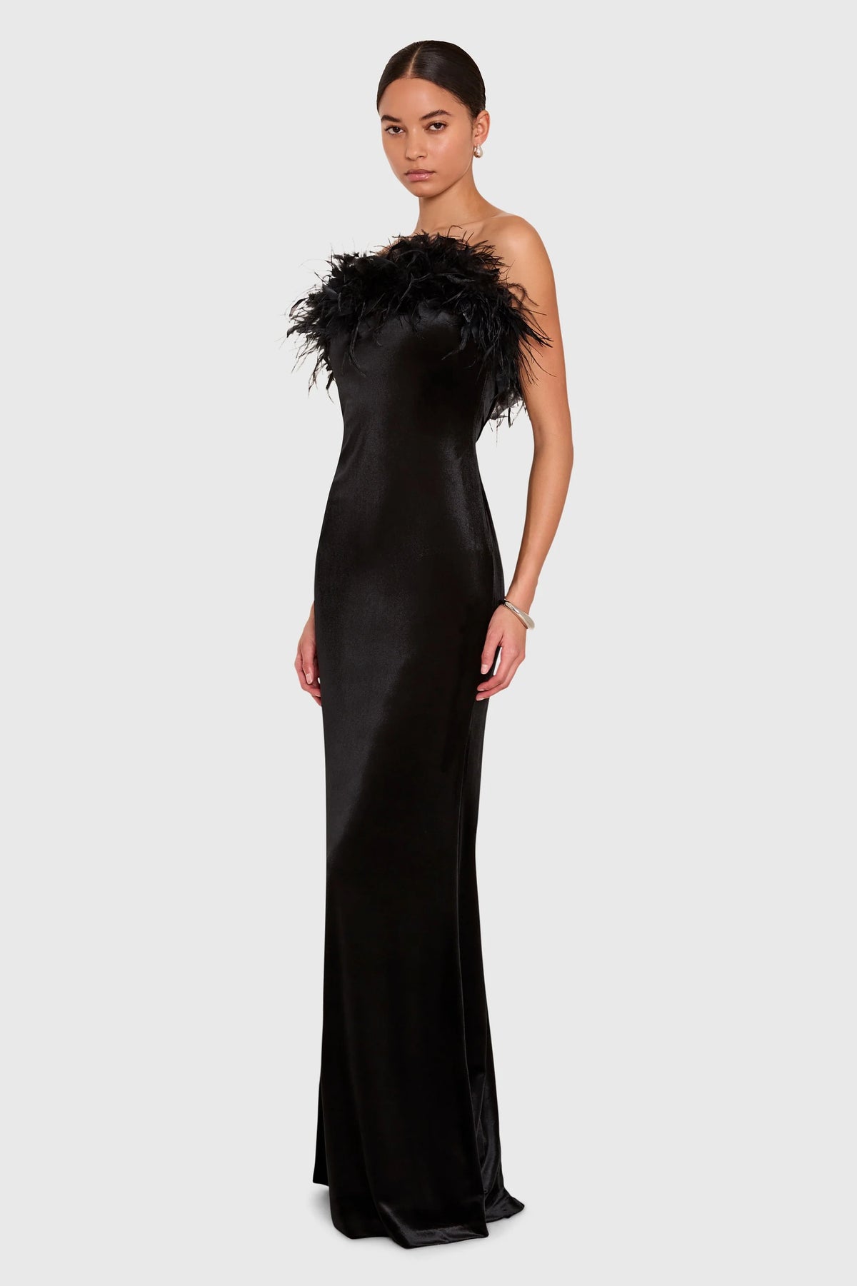 The Amanda Uprichard Ella Gown in black, a rich plush velvet. Strapless and finished with an ostrich feather trim at the neckline.