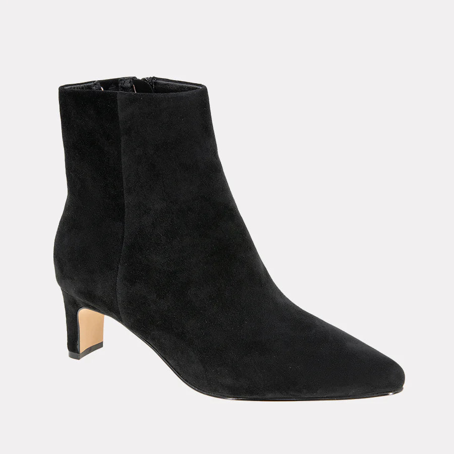 Black suede ankle boots on a light gray background