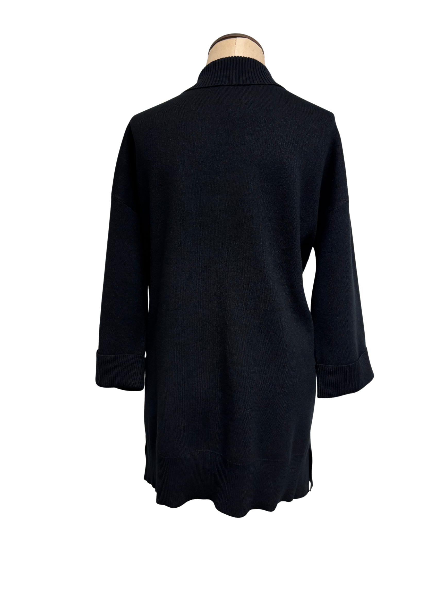 Black cardigan on a mannequin against a white background