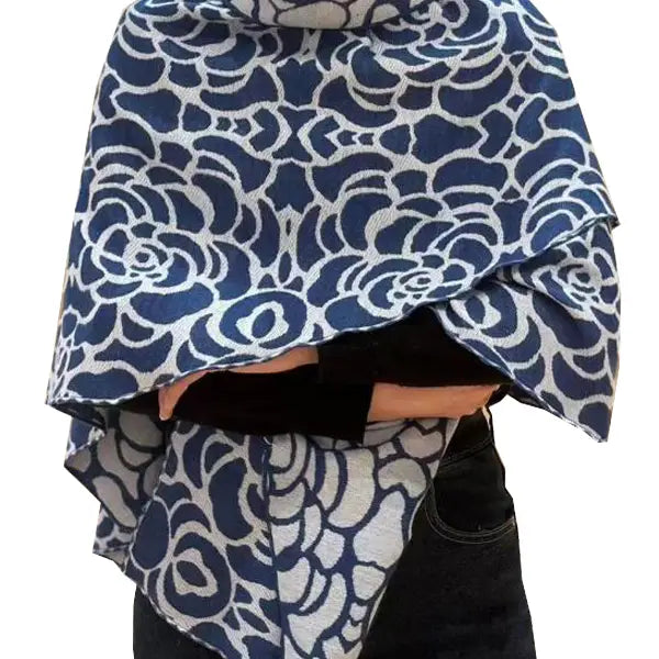 Blue and white patterned fabric draped over a person on a white background