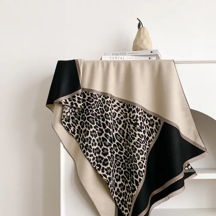 Cheetah print scarf draped over a mannequin against a white background