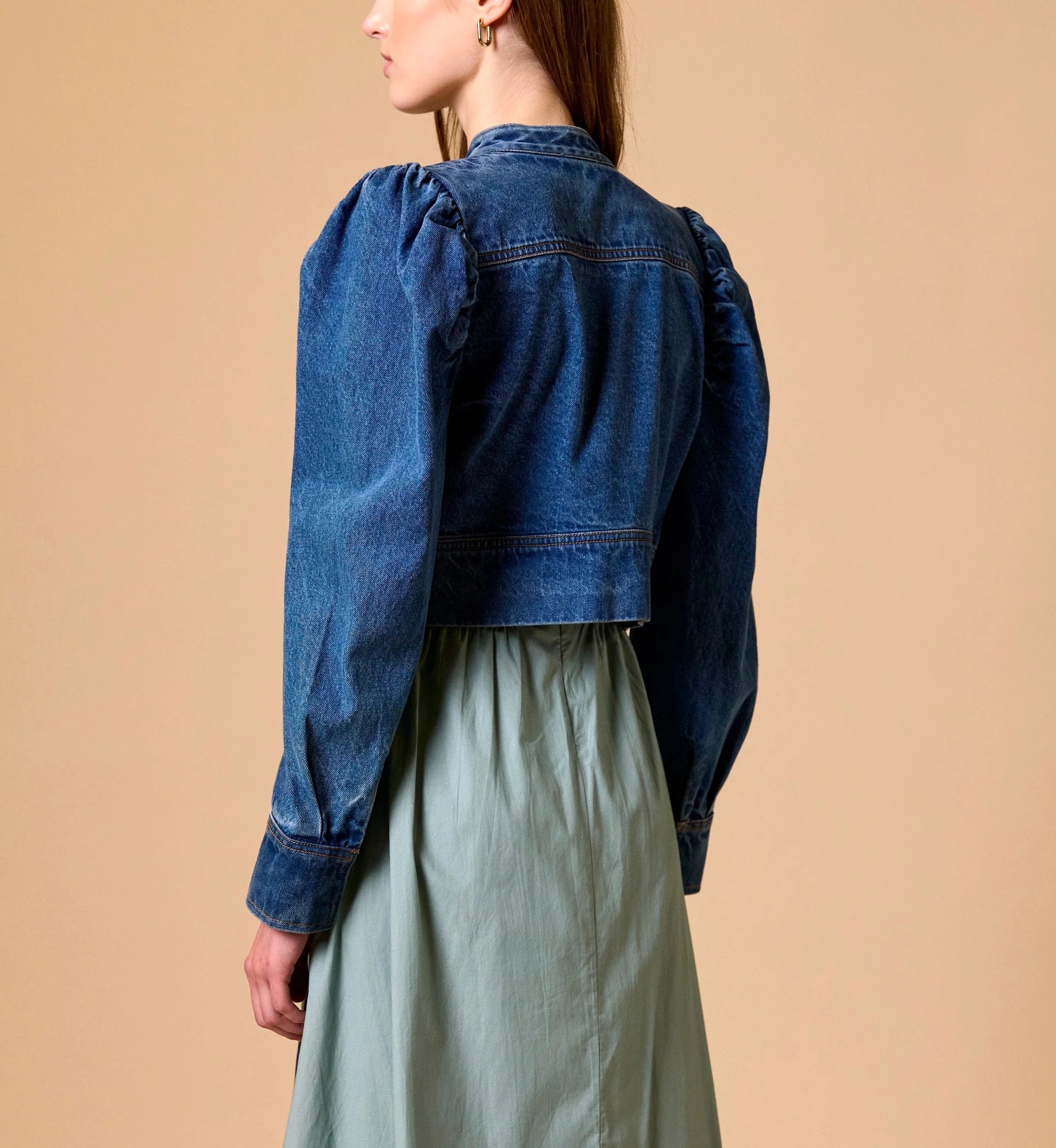 Woman Cleobella | Damien Denim Jacket blue denim jacket over a light green dress on a beige background