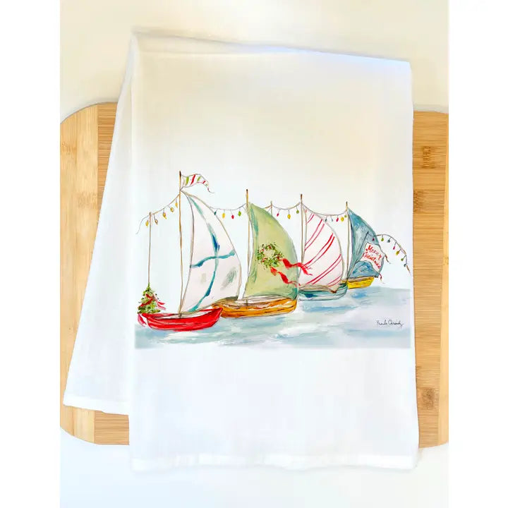 Towel with sailboat Christmas design on a wooden surface