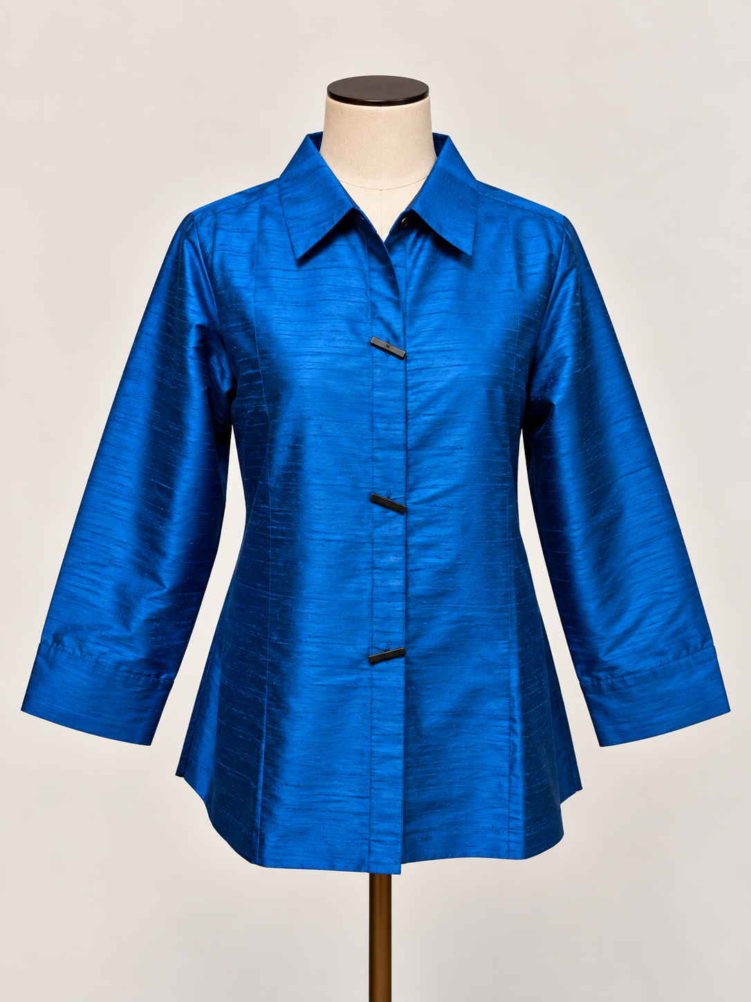 A bright blue silk textured long-sleeve blouse