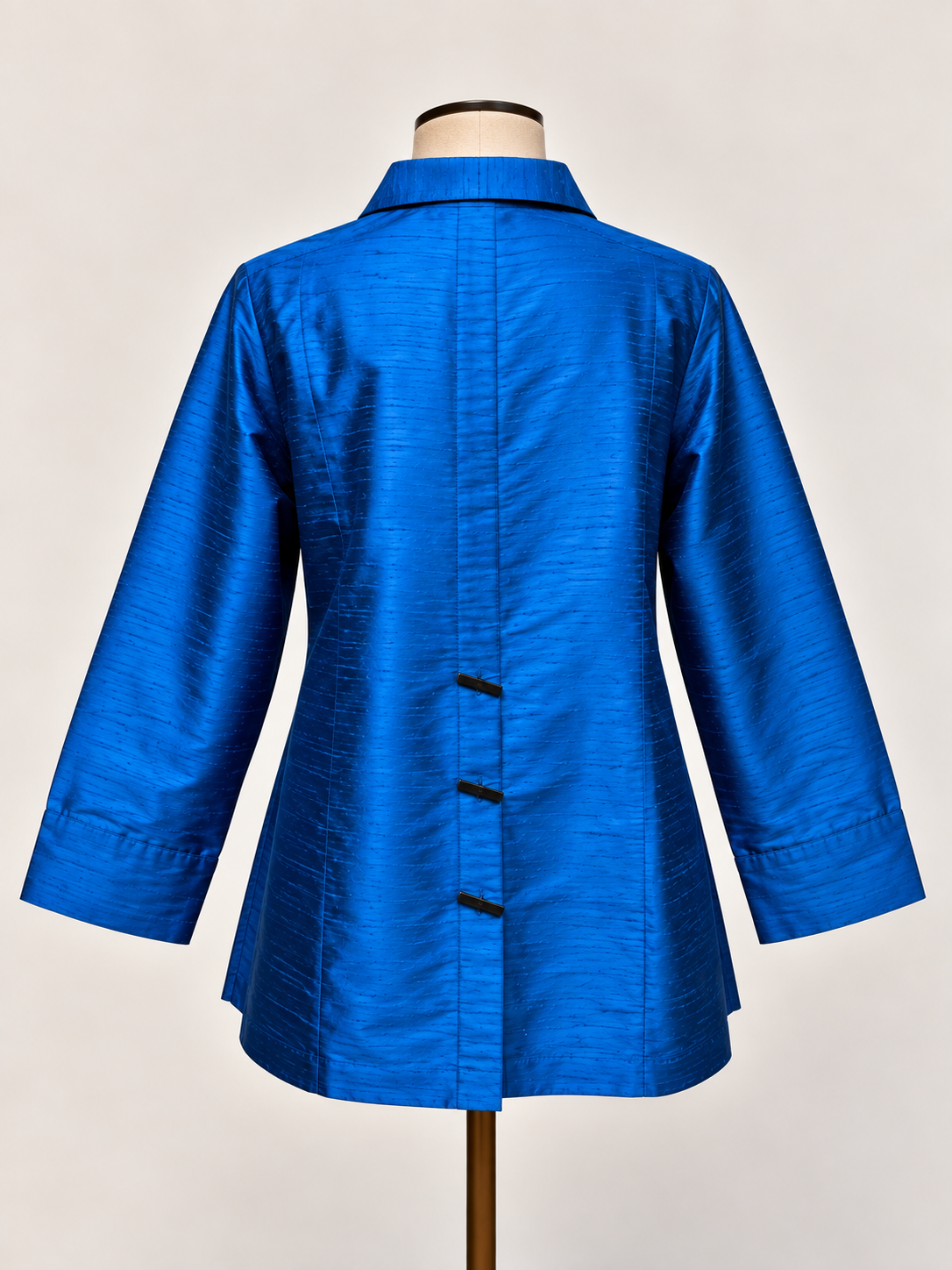A bright blue silk textured long-sleeve blouse