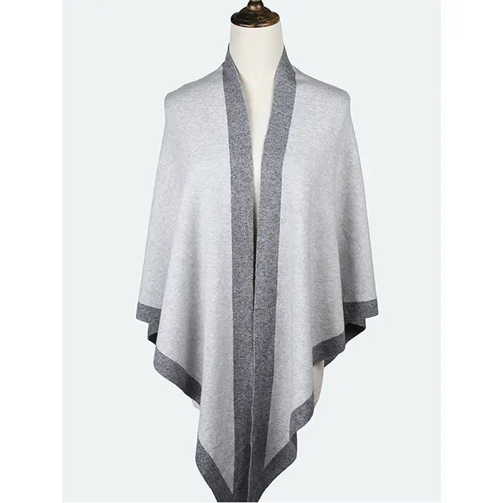 Gray and white striped shawl on a mannequin against a white background