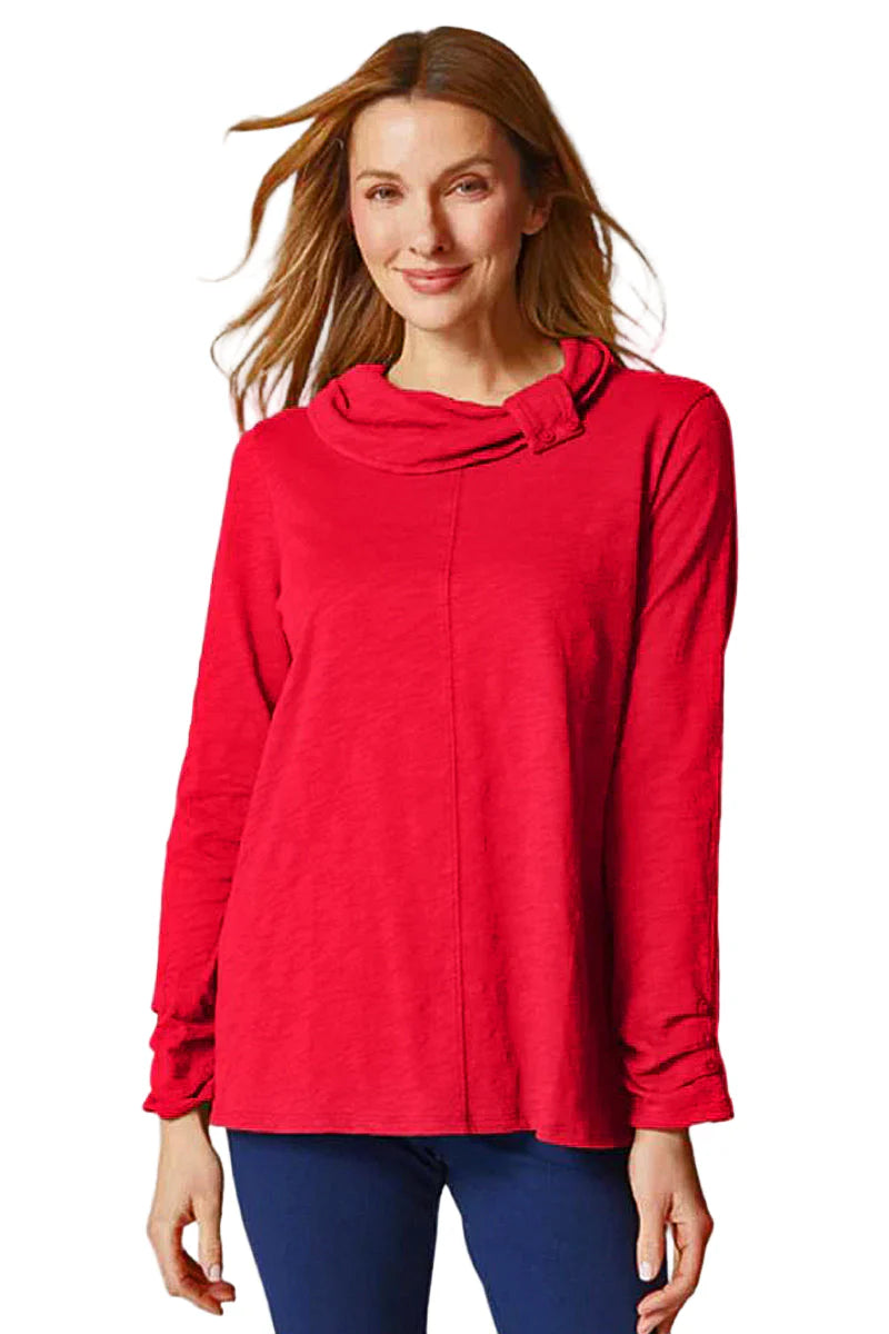 Woman wearing a red blouse with a cowl neck design on a white background