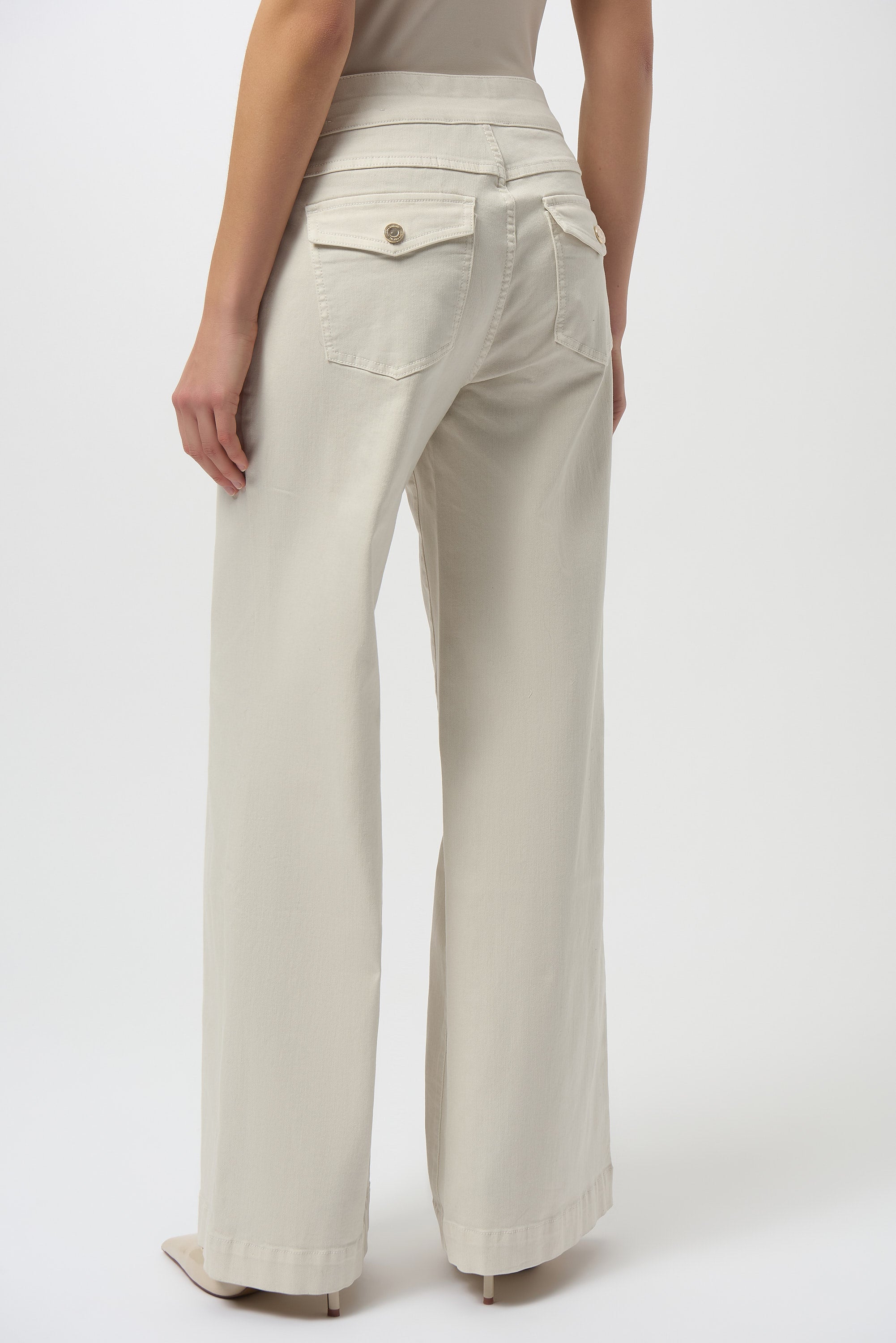 Beige wide-leg pants worn by a person on a white background