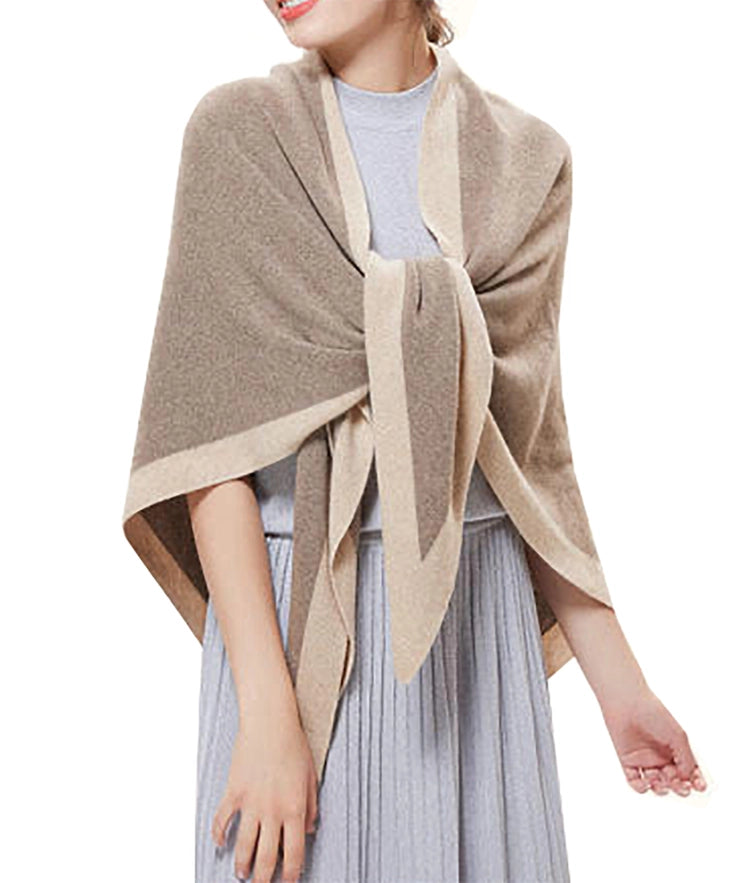 Woman wearing a beige shawl over a light gray dress on a white background