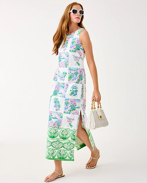 Woman wearing a colorful floral dress with a white background