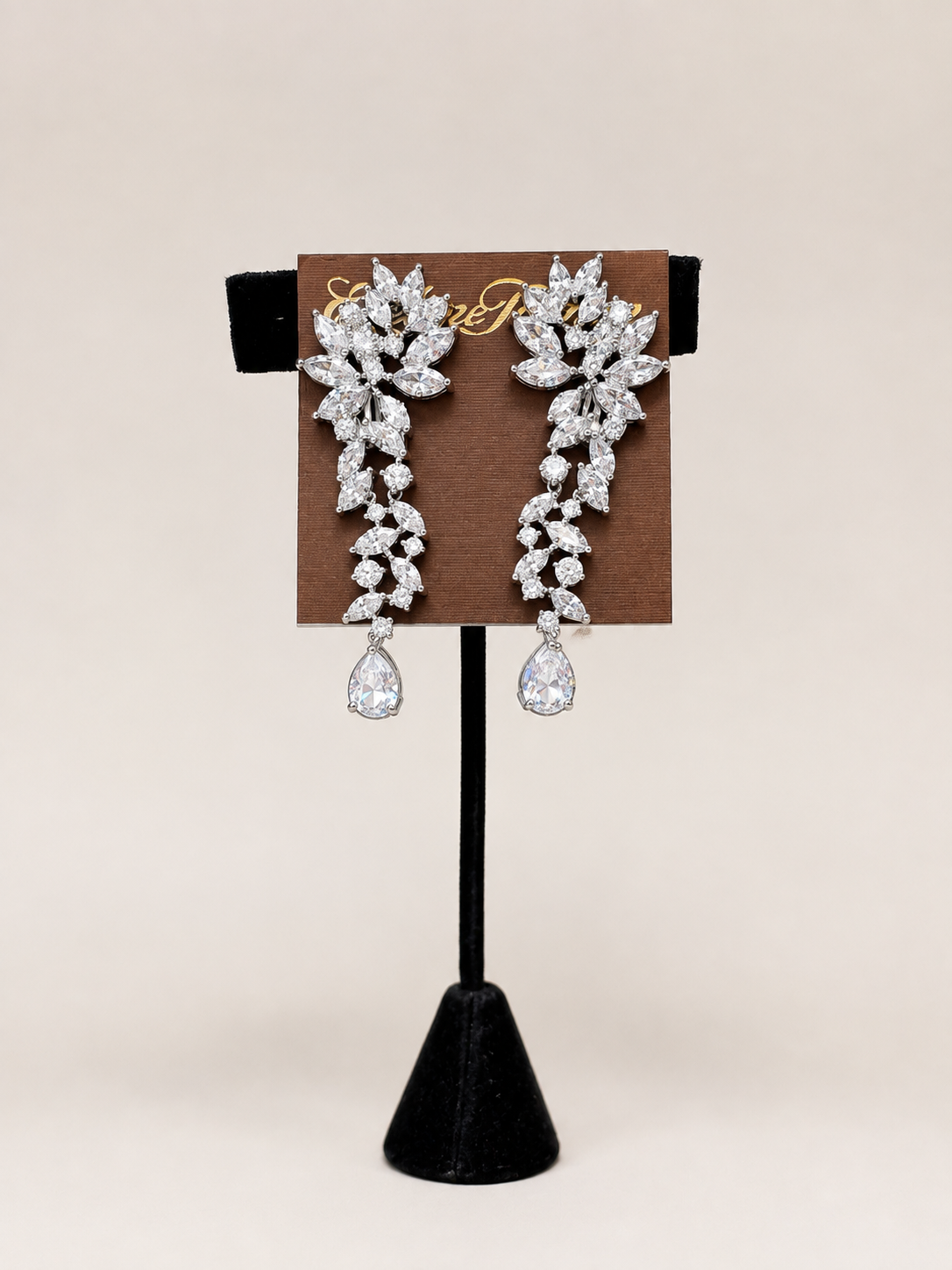 A pair of silver-toned drop earrings with clear gemstones arranged in a floral and vine pattern clip on earrings lordane Cubic Zirconia Drop Formal Earrings
