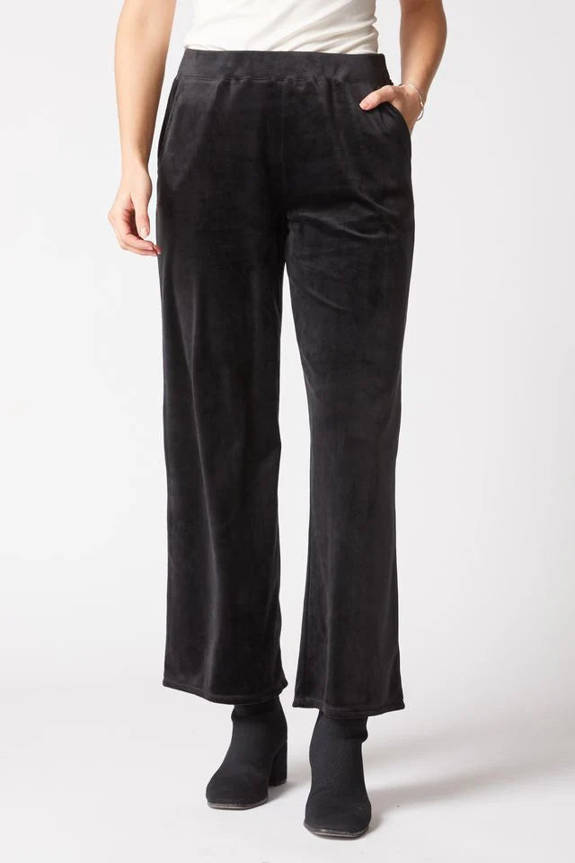 Person wearing black pants on a white background