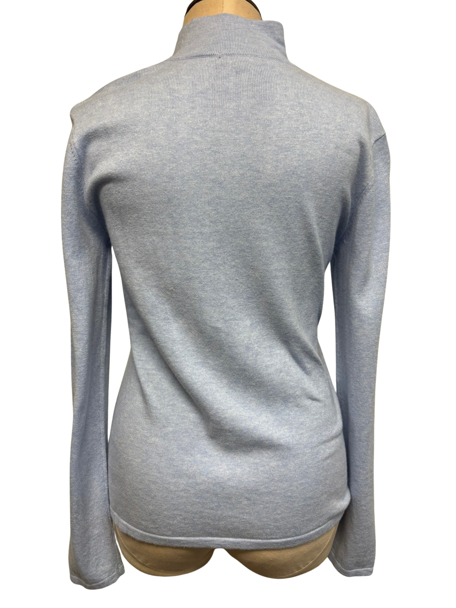 The back of a light sky blue zip-up cardigan on a mannequin against a white background