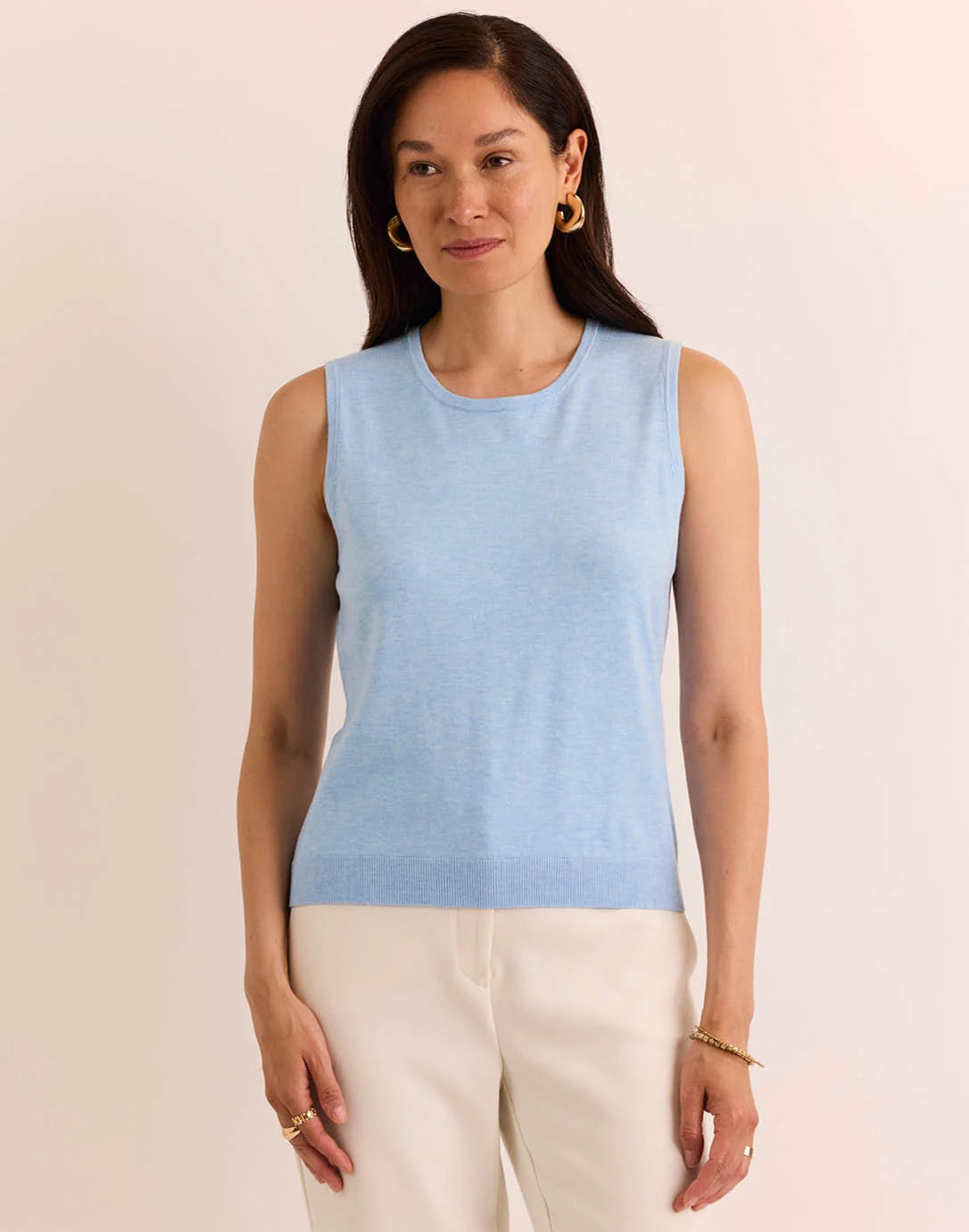Woman modeling a light blue sleeveless knit top with a crew neck the h edition Maria Sleeveless Ribbed Trim Shell sky blue heather