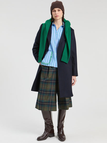 Model wearing Vilagallo blue and green striped ruffle-pocket shirt
