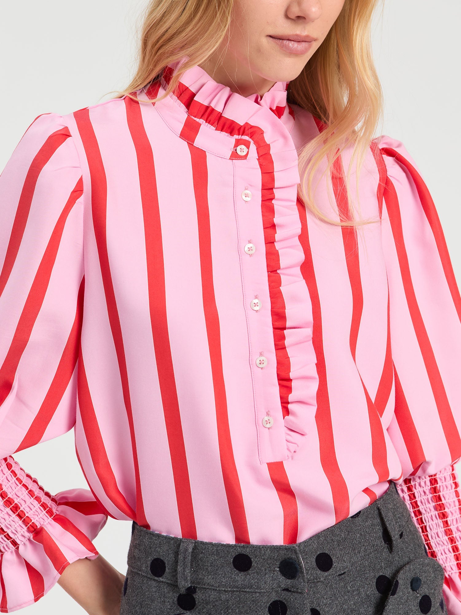 Detail of decorative ruffle high neckline on Vilagallo striped blouse