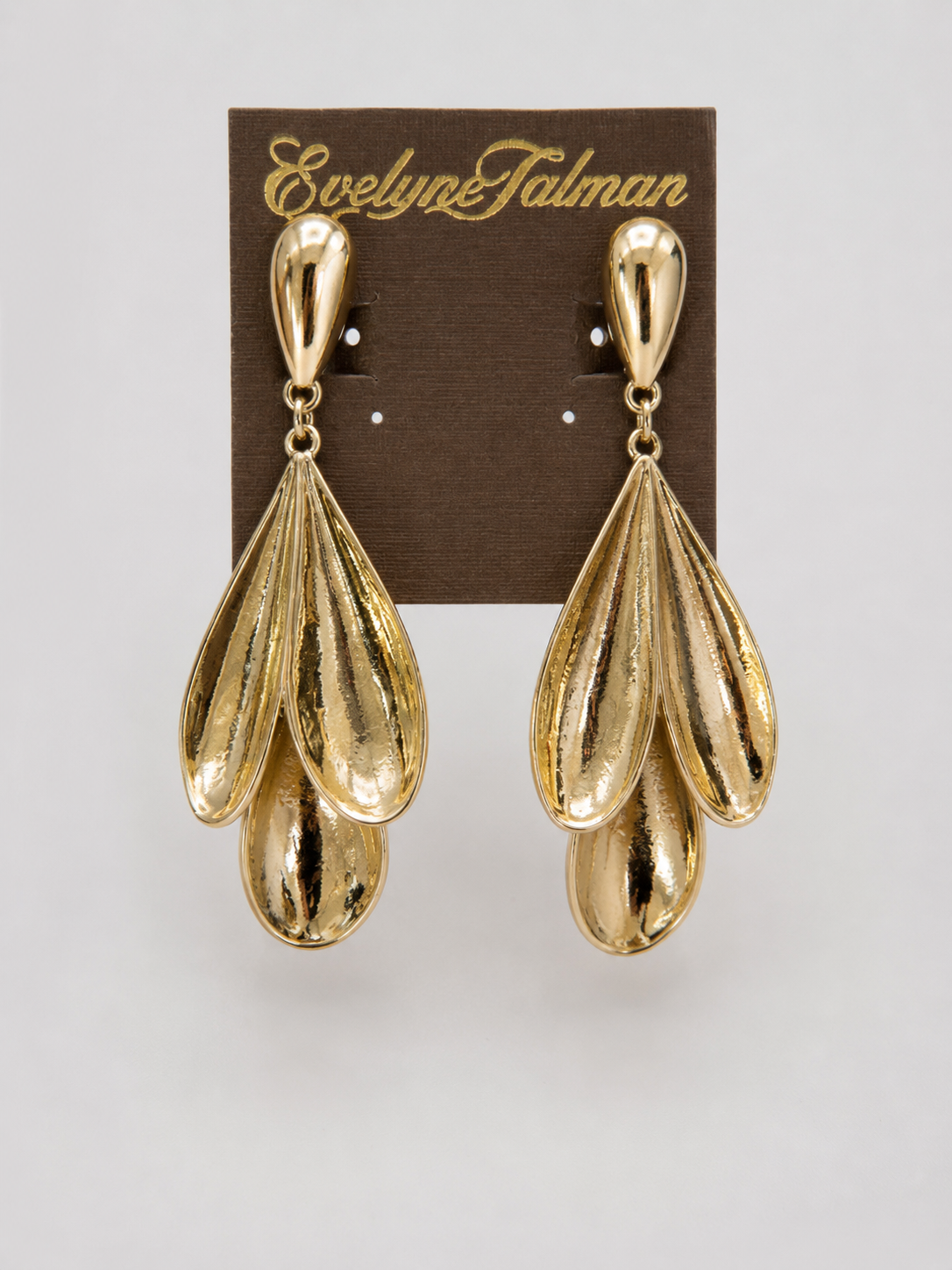 3 Petal Gold Drop Clip-on Earrings pair of gold-tone dangle earrings with a layered, teardrop-shaped design.