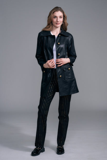 A woman modeling a black leather coat with gold-tone buttons by insight Vegan Leather Car Coat