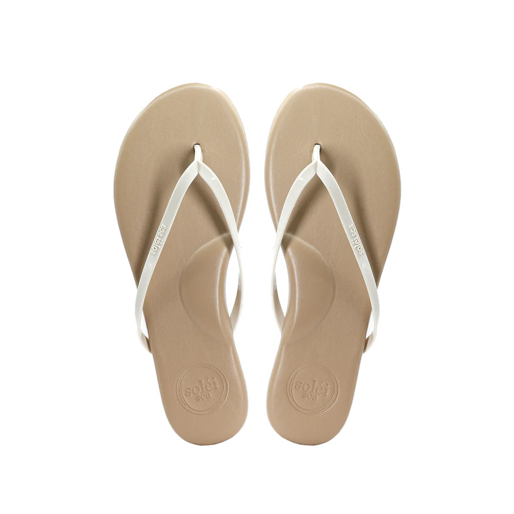 Pair of beige flip-flops with white straps on a white background
