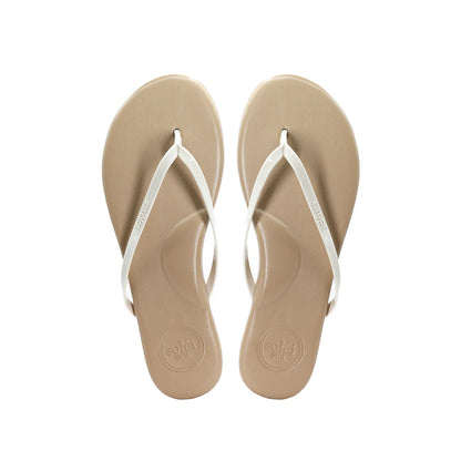 Pair of beige flip-flops with white straps on a white background