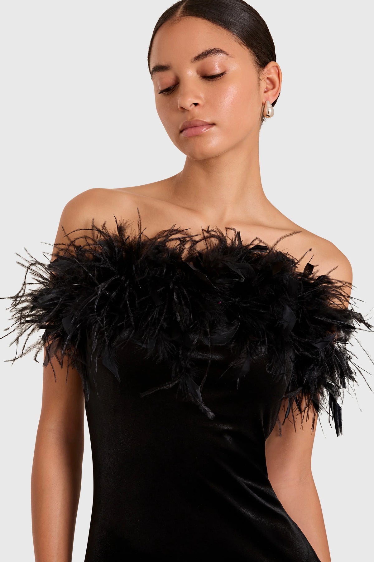 The Amanda Uprichard Ella Gown in black, a rich plush velvet. Strapless and finished with an ostrich feather trim at the neckline. Style No. VE-23164