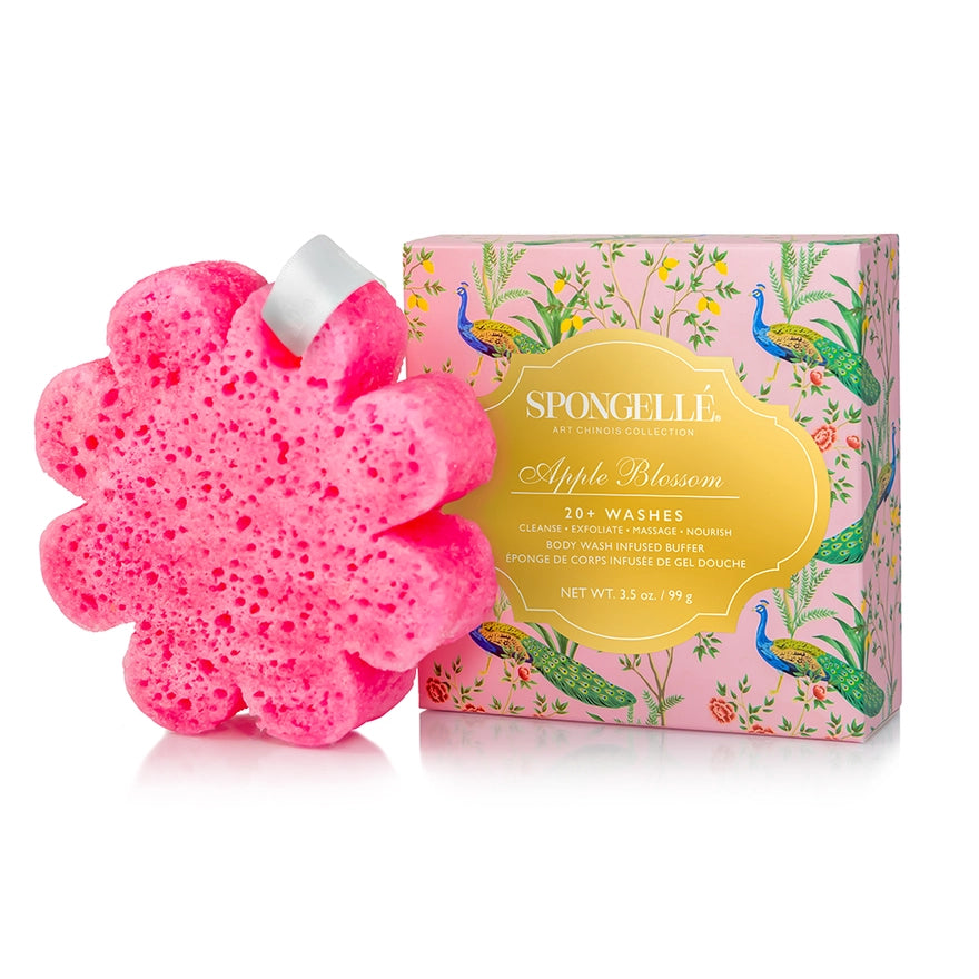 Pink flower-shaped sponge with packaging featuring peacocks and floral design on a white background