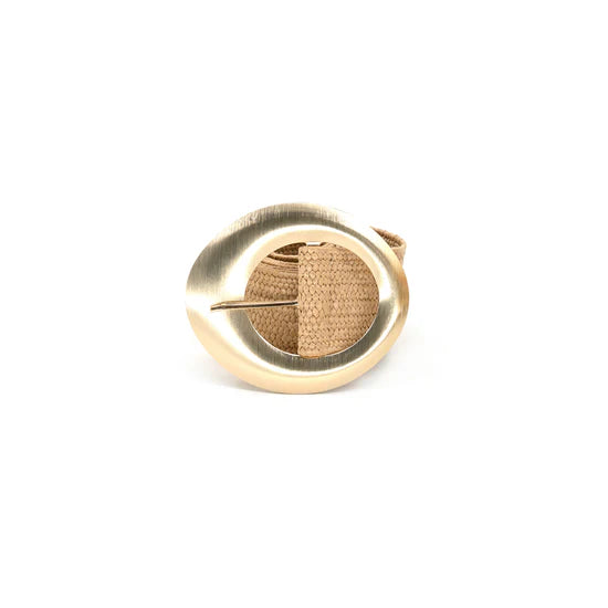 Gold brooch with textured center on a white background