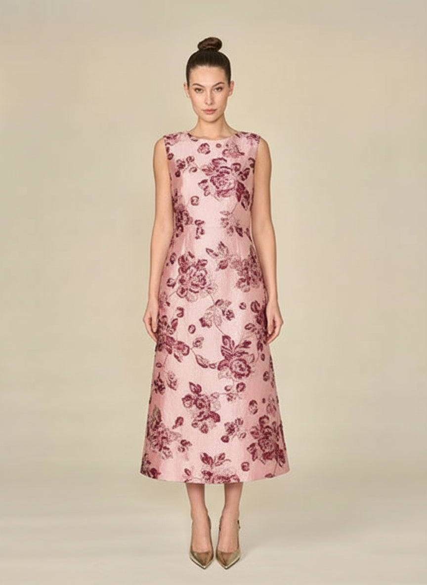 Woman wearing a pink floral dress on a beige background