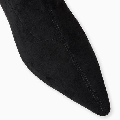 Close-up of a black sock with a pointed toe on a white background