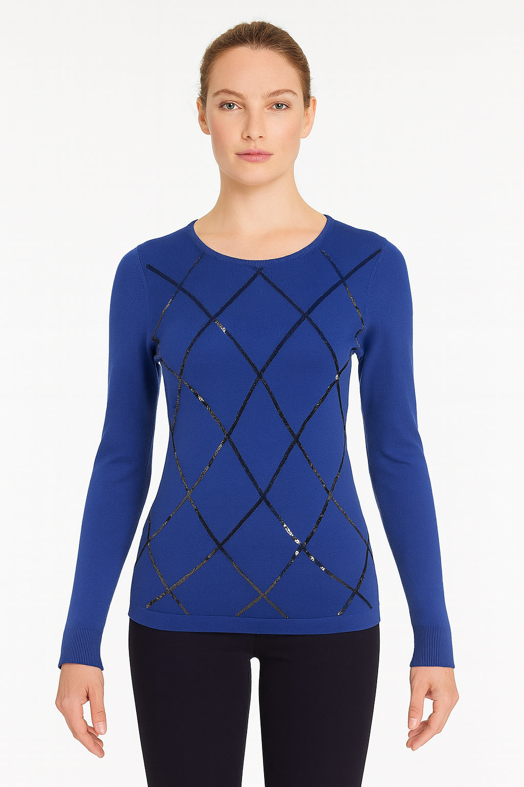Woman wearing a blue long-sleeve top with black lattice design on a white background