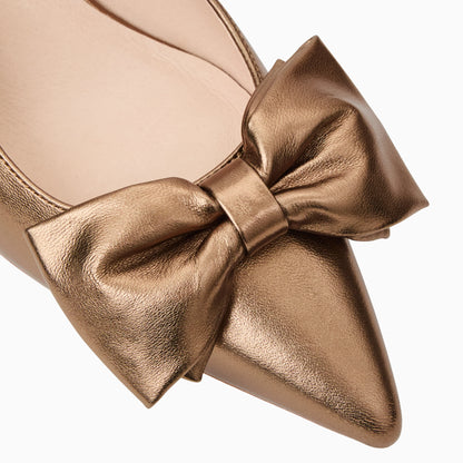 Bronze gold shoe with a large bow on a white background