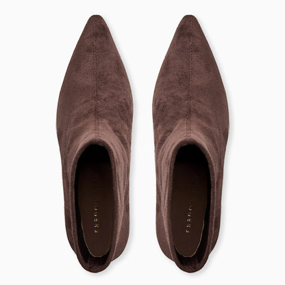 Pair of brown suede pointed-toe shoes on a white background