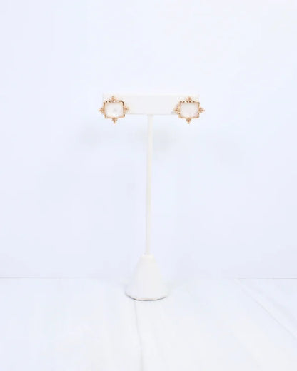 Caroline hill Kerang Square Facited Stud Earring White a pair of gold-tone stud earrings with square white mother-of-pearl centers.