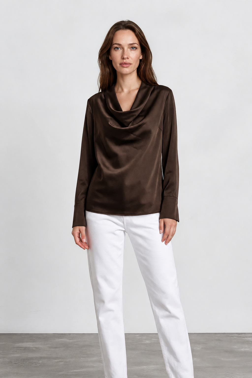 A woman modeling a dark brown cowl-neck satin blouse