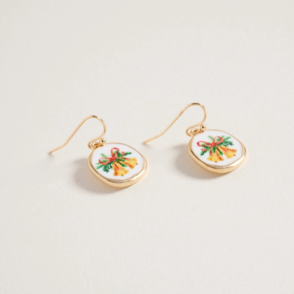 Gold earrings with circular designs featuring colorful Christmas bells bows on a light gray background