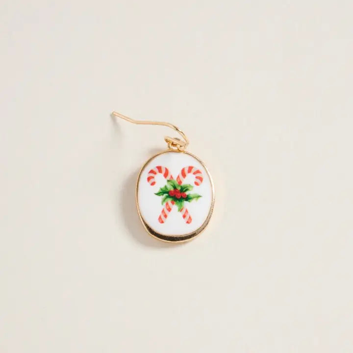 Earring with candy cane design on a beige background